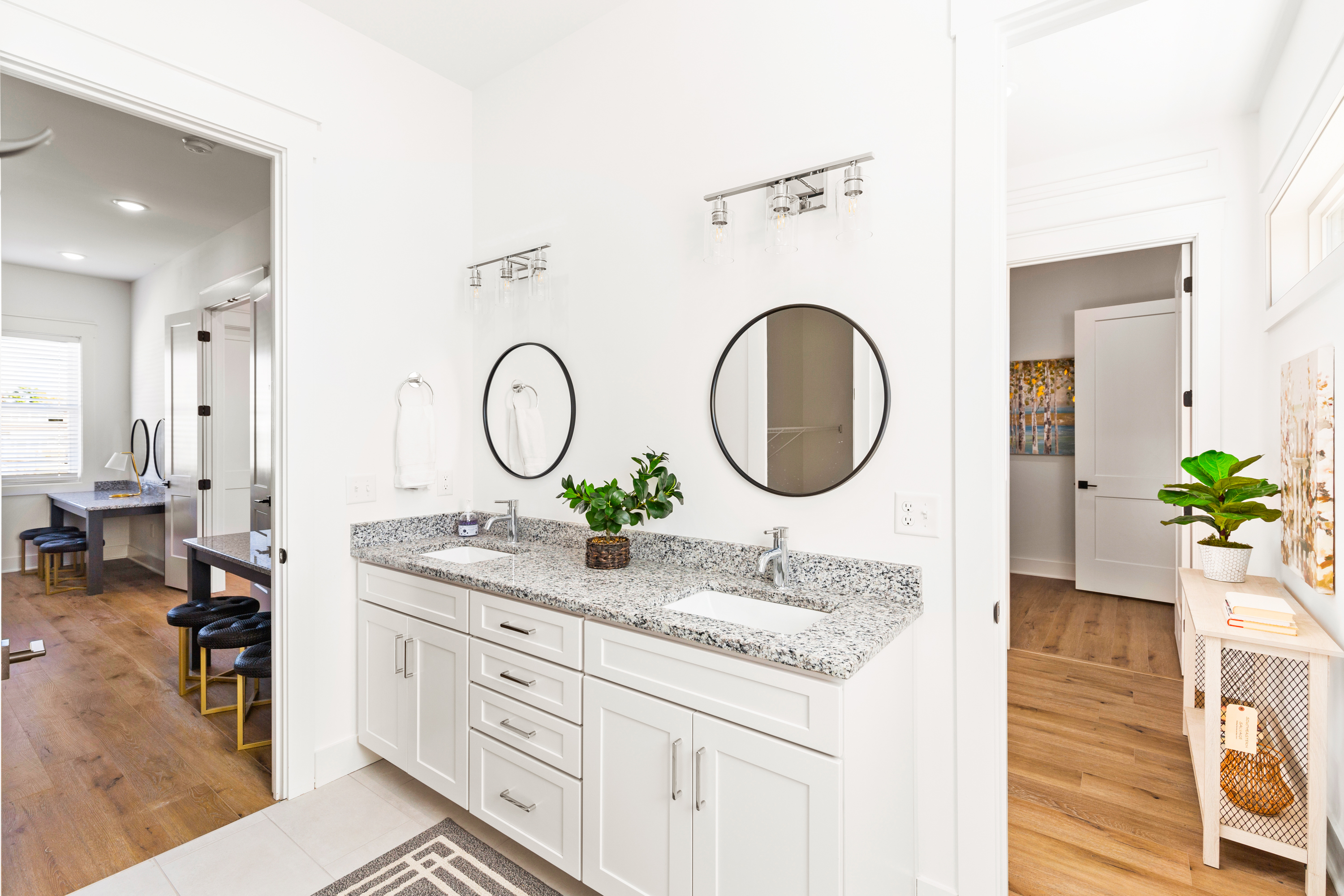 Modern bathroom with white cabinetry and granite countertops